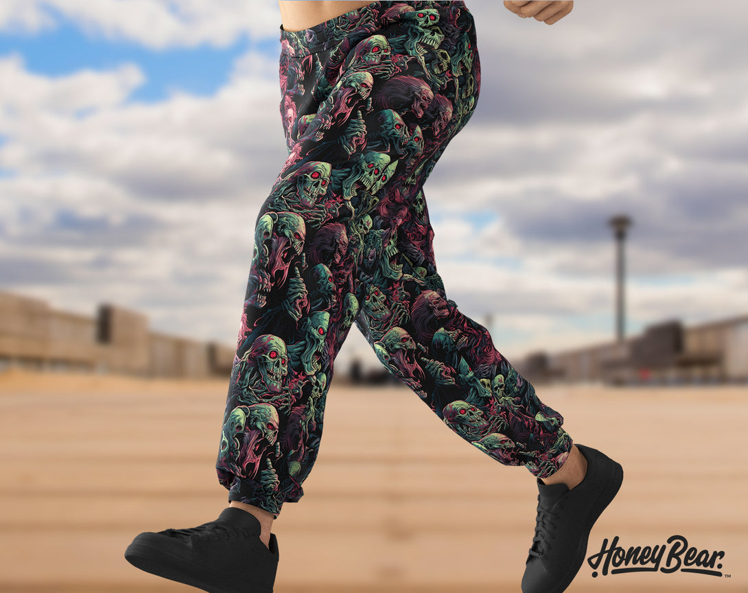 man wearing Creepy Undead Jogger Pants with Zombies faces pattern