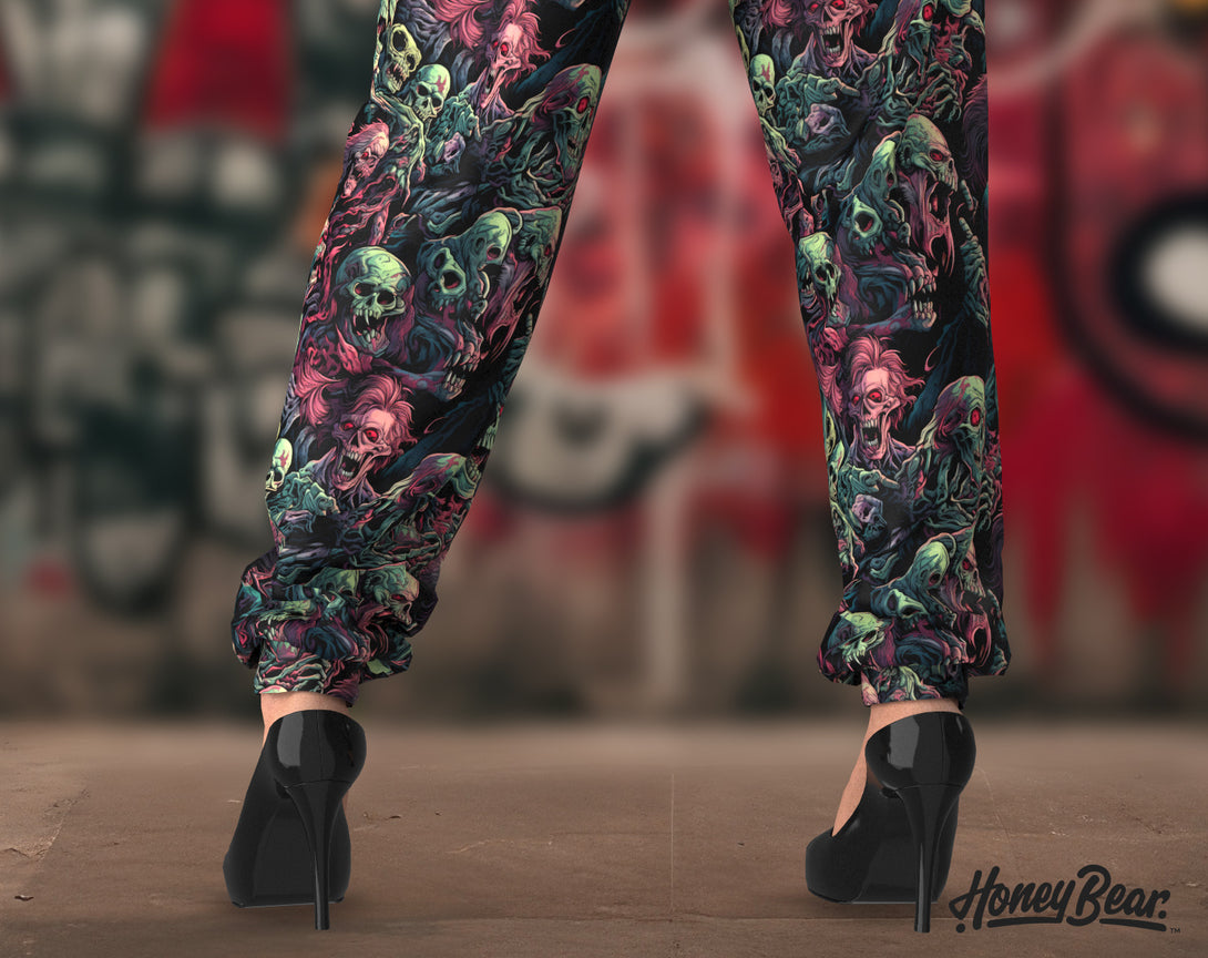 closeup of woman's legs in Creepy Undead Jogger Pants with Zombies faces pattern