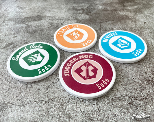Set of four ceramic coasters featuring vibrant illustrations of iconic perks from zombie survival games.