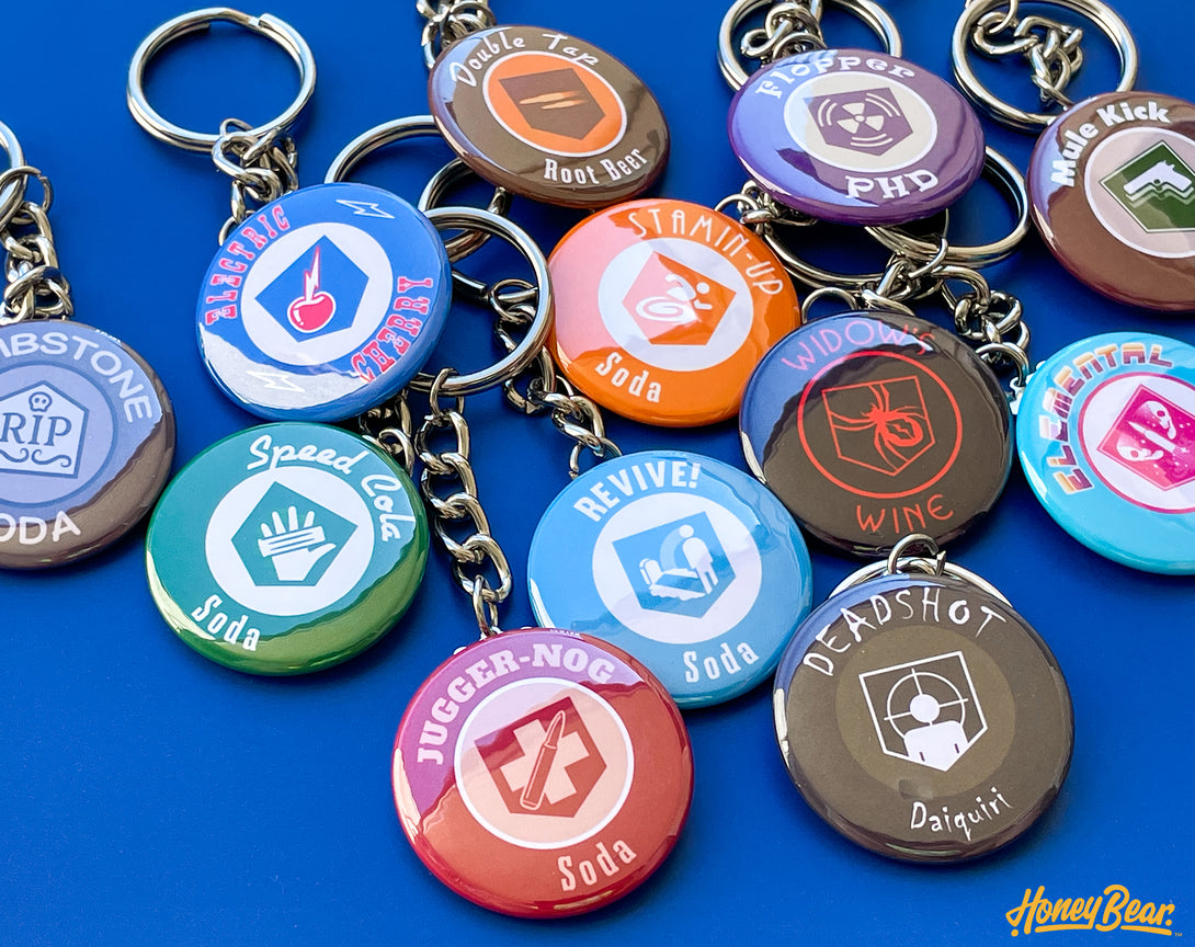 Assortment of collectible gaming keychains, each representing a unique perk from popular zombie survival games.