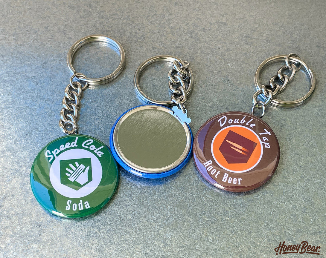 Close-up of intricately designed zombies perk keychains, perfect for gaming enthusiasts.